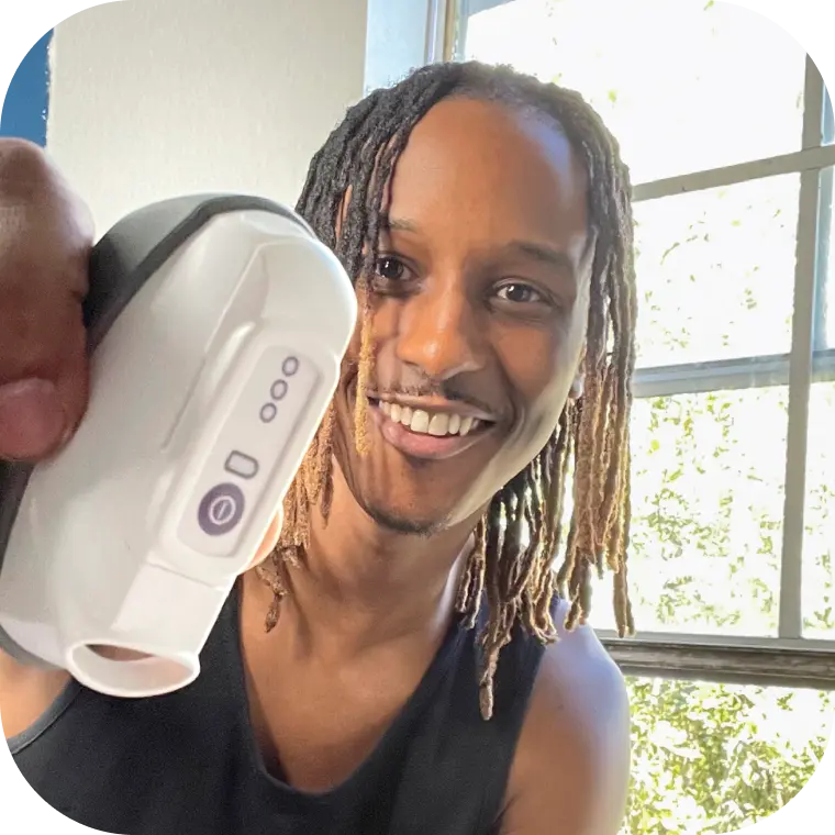 Person holding their CalmiGo device