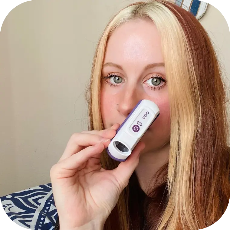 Person holding their CalmiGo device